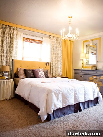 Main bedroom with a repainted dresser featuring a flower motif, and a beautifully tufted and upholstered headboard.