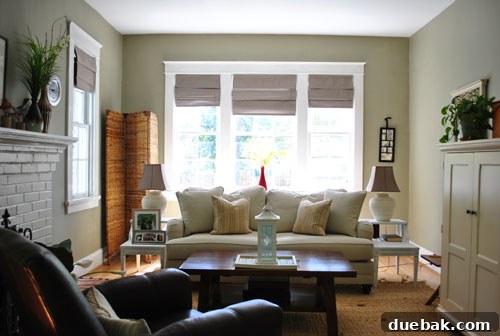 Bright & Beautiful Homes 5 Spacious living room in a Westover Hills home, featuring large windows flooding the space with natural light, high ceilings, traditional molding, and a stylish hidden home office armoire.