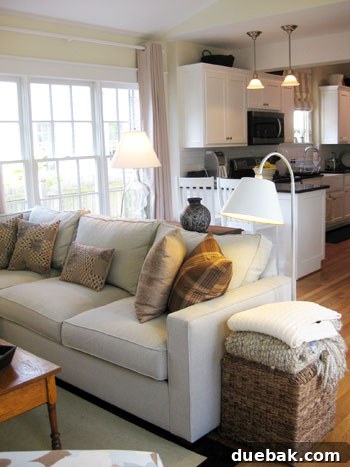 Bright & Beautiful Homes 9 Cozy family room with a comfortable sectional sofa, abundant natural light streaming through floor-to-ceiling windows, creating a bright and inviting space for relaxation.