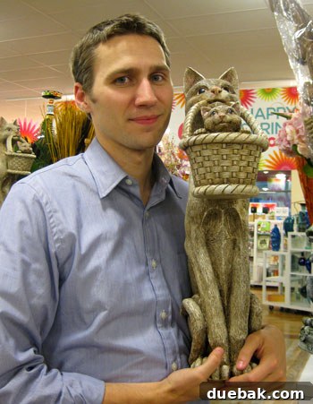 My HomeGoods Daydream 6 Quirky cat statue holding a basket with a kitten, a humorous HomeGoods find.