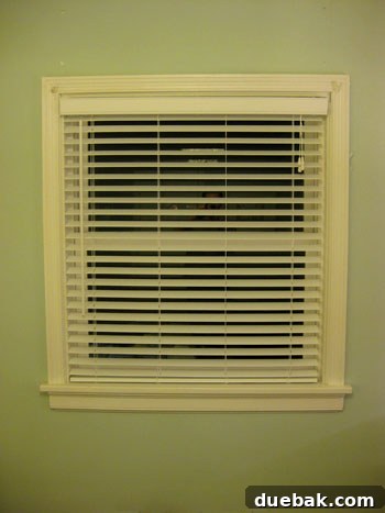 John adjusting the length of the faux wood blinds
