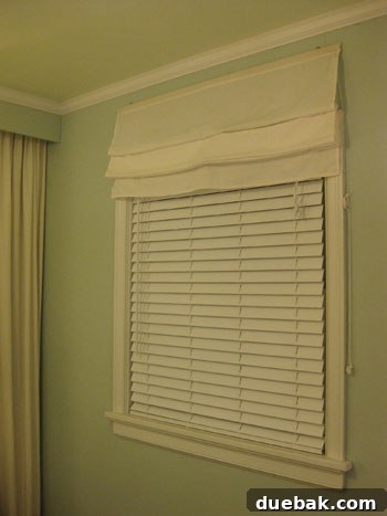 Bedroom window with new faux wood blinds providing darkness