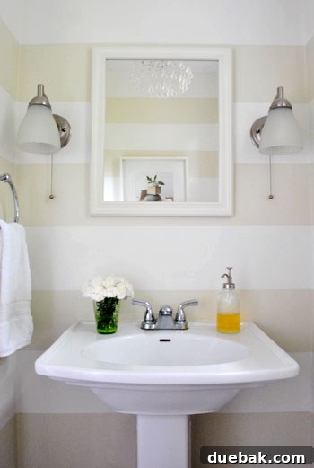 May Bloom Bonanza 6 Cream carnations in a green drinking glass in a half bathroom