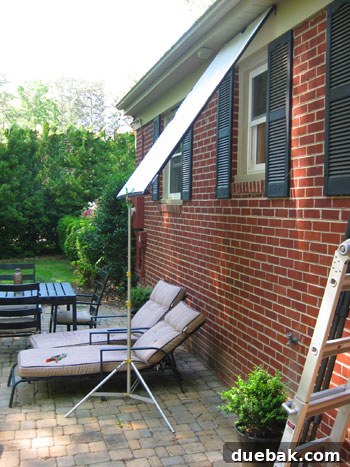 Crew using a scrim to diffuse natural light during a photoshoot