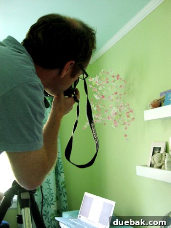 Photographer adjusting camera angle on a tripod, capturing a unique perspective