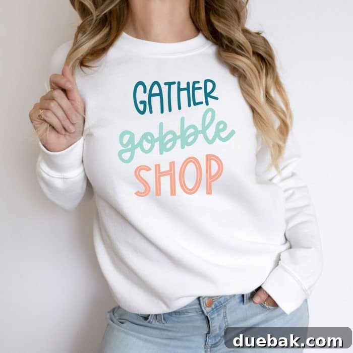 Detail shot of a black sweatshirt showcasing the 'Gather Gobble Shop' Black Friday SVG design, ready for the holiday season.