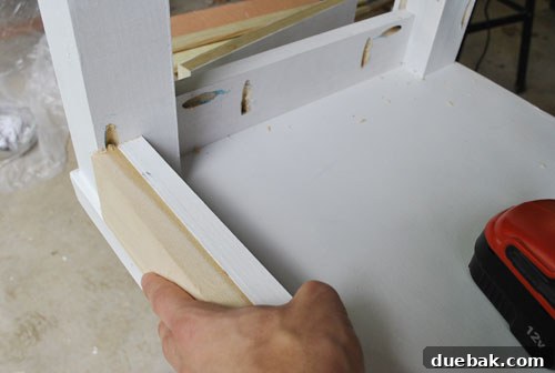 From Door to Desk: Craft Your Perfect DIY Workspace 17 Desk rail with pilot holes drilled, using a guide