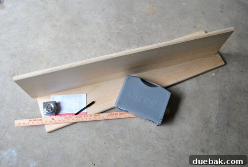 Pine boards laid out on a workbench with tools, illustrating the start of a DIY woodworking project.