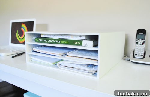 A stylish desktop organizer with multiple open shelves, designed for scrapbooking, now used for office supplies.