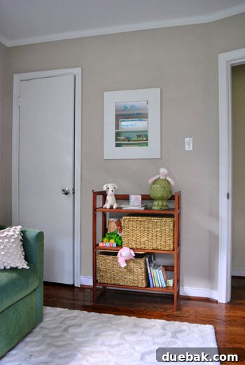 A small, child-friendly bookcase filled with books and toys in a compact room setting.