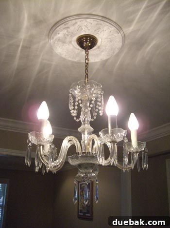 Vintage crystal chandelier before makeover with modern drum shade