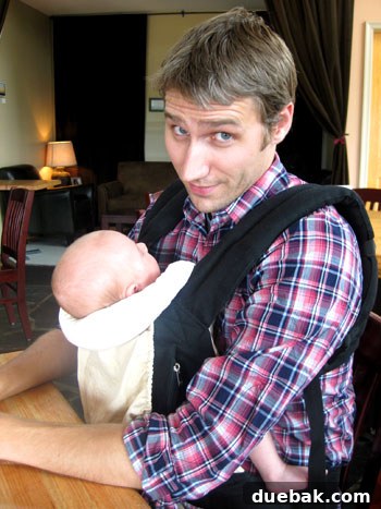 Our Third Anniversary Wedding Week 11 Dad holding baby in carrier inside brewery