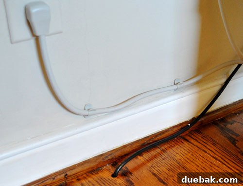 Untangle Your Tech Cables 18 Cleaned up wall outlet with cable clips