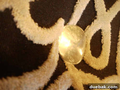 Handcraft Your Perfect Ottoman 12 Close-up of a completed tufted button on the ottoman