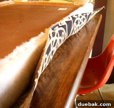 Handcraft Your Perfect Ottoman 4 Fabric partially stapled to the ottoman base