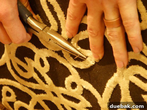 Handcraft Your Perfect Ottoman 9 Needle being pushed through the ottoman from back to front