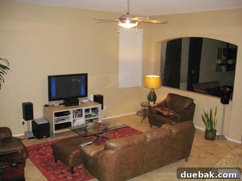 Worldly Living Room Makeover Before Dated family room before its global-chic makeover, featuring an uninspired layout and lack of cohesive style.