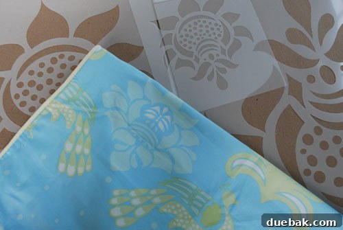 Close-up of the stenciled wall in Benjamin Moore Morning Glory paint, showcasing the intricate white pattern.