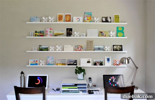 Craft Your Own Stylish Wall Shelves 13 Close-up of DIY art ledges filled with a diverse collection of postcards and small artworks
