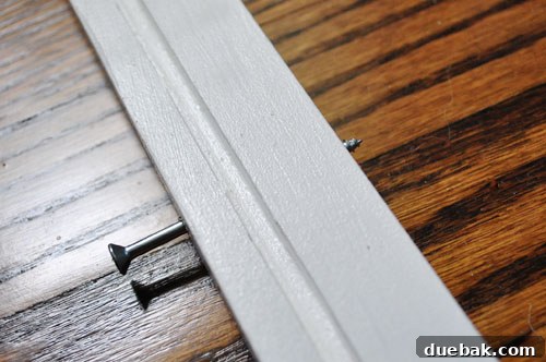Craft Your Own Stylish Wall Shelves 10 Close-up of a DIY shelf being installed, with screws aligning with drywall anchors