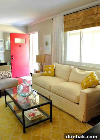 Two vibrant yellow ruffled throw pillows displayed on a sofa, with a subtle patterned yellow rug visible in the background, creating a cohesive look.