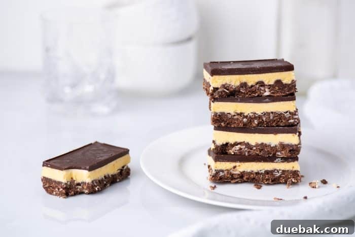 A stack of Nanaimo bars - a traditional Canadian dessert - in a white kitchen, ready to be served.