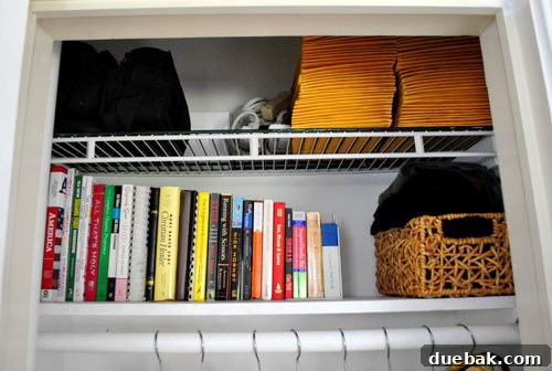 Clever Closet Shelf for Built-In Dog Crate 12 Upper shelf of the closet, organized with books, scarves, and mailing envelopes