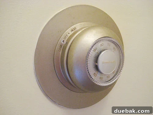 oldhoneywellthermostat Old, outdated Honeywell thermostat on a wall