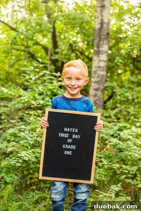A child holding a personalized back-to-school sign, showcasing a different style of printable or prop.