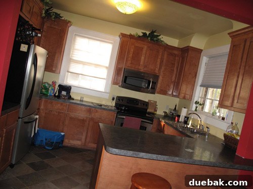 The Thousand Dollar Kitchen That Looks Like a Million 2 Before kitchen view showing original cabinets, appliances, and layout with dated finishes.