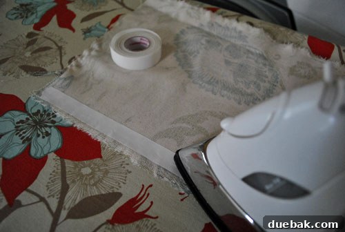 Transform Cork Into Chic Fabric Vases 8 Iron-on heavy duty hem tape being applied to fabric, a key step for creating polished edges on a DIY fabric vase.