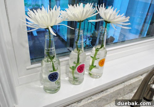 Transforming Izze Bottles into Stylish Vases 3 Close-up of white spider mums in colorful Izze bottles