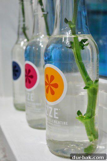 Transforming Izze Bottles into Stylish Vases 5 Artful arrangement of flowers in repurposed bottles on a table