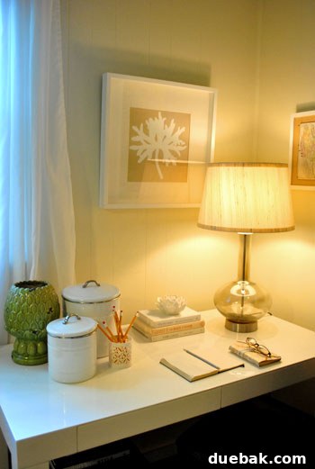 New coral leaf botanical print art hanging above the desk, adding a fresh and colorful element to the updated den decor.