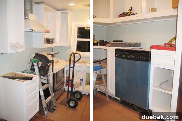 Kitchen renovation progress with new cabinets, dishwasher, and range hood
