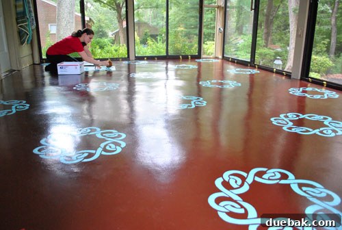 Transform Your Concrete Floor with Paint and Stencils 11 Working around the room with paint supplies on cardboard