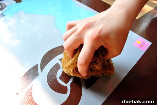 Transform Your Concrete Floor with Paint and Stencils 4 Applying paint to the stencil with a sponge