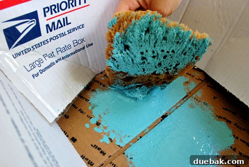 Transform Your Concrete Floor with Paint and Stencils 8 Dabbing excess paint off the sponge onto cardboard