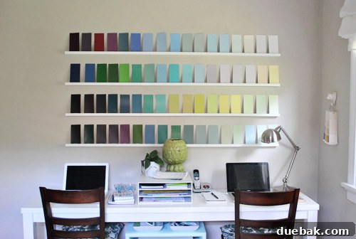 The office wall after the DIY makeover, now adorned with an appealing arrangement of colorful paint swatches.
