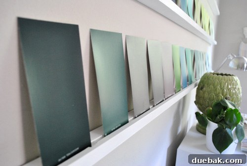 Close-up of the paint swatches arranged on the wall, showing how they lean and the overall texture and depth.