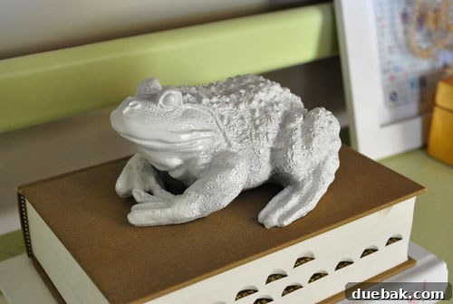 A ceramic frog sculpture, after being painted glossy white, appearing charming and modern, transformed from its original state.