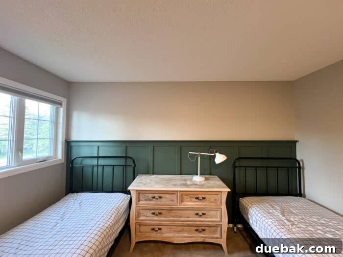 Shared Boys' Room Transformation: Feature Wall Impact 4 Partially decorated shared boys room showing new beds, matching bedding, and a sophisticated board and batten feature wall