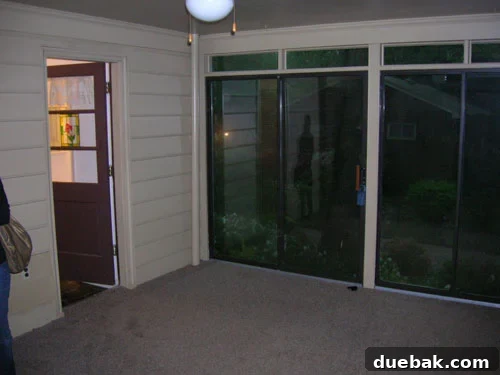 Before sunroom with matted rug and outdated decor