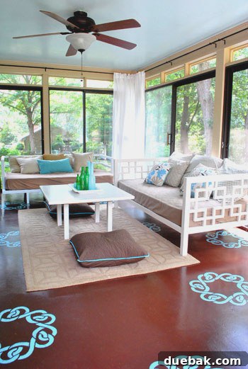 Aqua floor stencils complementing blue ceiling in bright sunroom