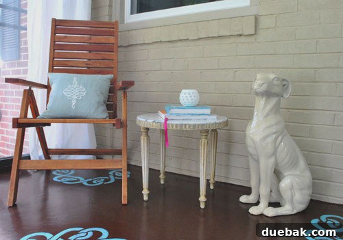 Marble side table and a beloved ceramic dog statue in a sunroom corner