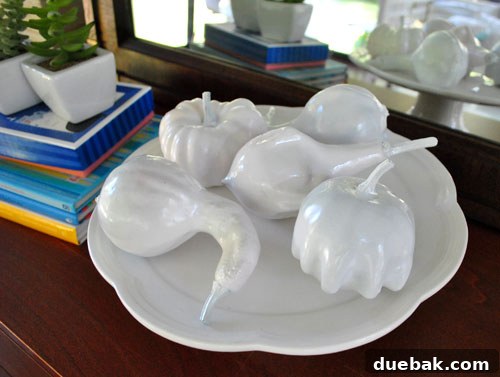 Gourd-geous Autumn Crafts 4 A group of glossy white faux gourds arranged artfully on a surface.