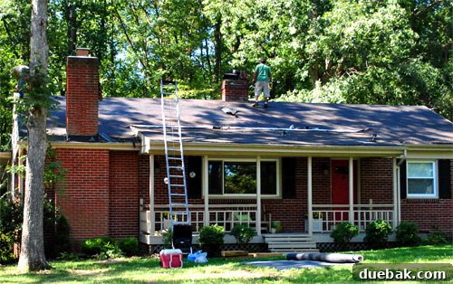 Roofing crew working on the house in hot weather