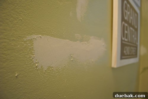 Close-up of a wall being sanded, showcasing the DIY home repair process