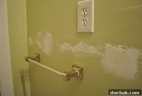 Another angle of spackle sanding, emphasizing meticulous wall preparation