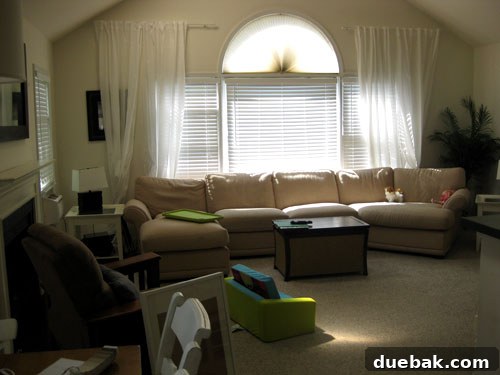 Farah's Living Room Makeover: The Finished Look 3 Before image of Farah's family room with neutral walls and existing furniture